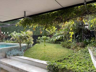 Green on every side, seen from under the pergola